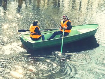 People sitting on boat in river