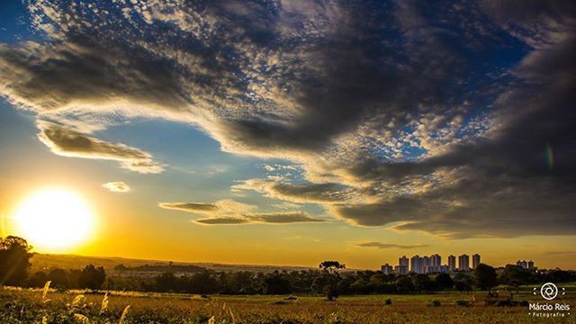 sunset, sky, landscape, field, cloud - sky, scenics, tranquil scene, beauty in nature, tranquility, nature, building exterior, rural scene, sun, sunlight, idyllic, orange color, cloudy, built structure, architecture, cloud