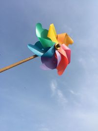 Low angle view of colorful pinwheel toy against sky