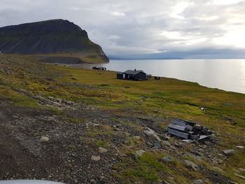 Scenic view of sea and mountains against sky