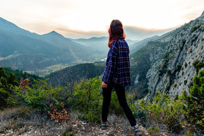 Full length of woman walking on mountain against sky