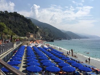 People at beach against sky