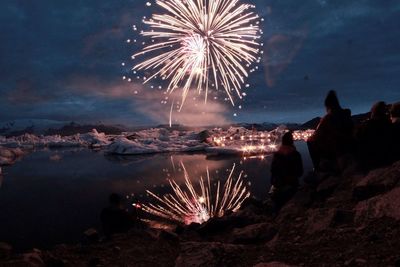 Low angle view of firework display at night