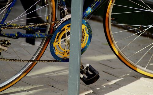 Close-up of bicycle parked on footpath