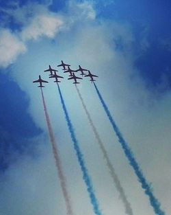 Low angle view of airplane flying against sky