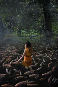 Woman in the beautiful nature pond