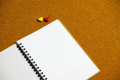 High angle view of blank spiral notebook on table