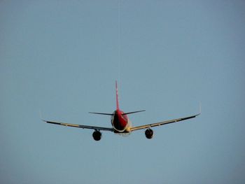 Low angle view of airplane against clear sky