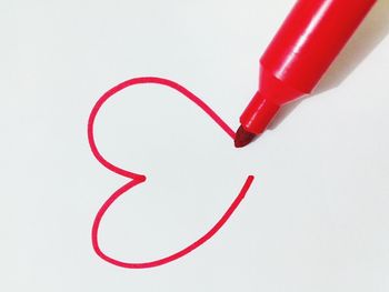 Close-up of red paint on white background