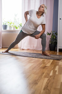 Full length of woman exercising in gym