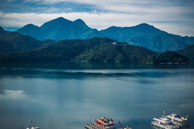 Scenic view of lake and mountains against sky