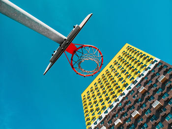 Low angle view of basketball hoop against blue sky