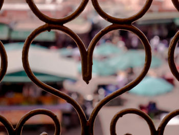 Close-up of heart shape metal against sky