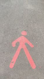 High angle view of arrow sign on road in city