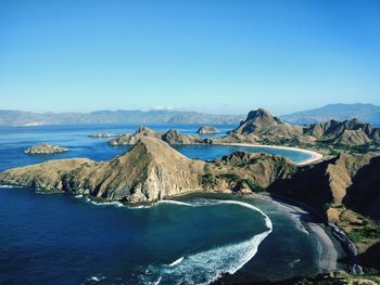 Panoramic view of sea and mountains against clear blue sky