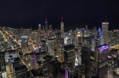 High angle view of illuminated buildings in city at night