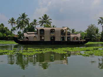 Built structure by lake against sky