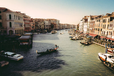 Boats in river with buildings in background