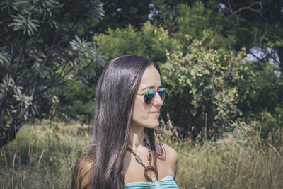 Portrait of young woman with plants