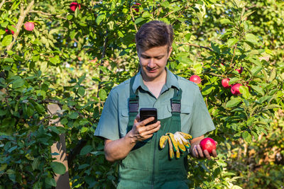 Portrait of young man using mobile phone