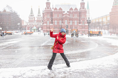 Full length of woman standing in snow