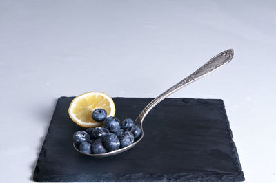 High angle view of fruits on table against white background