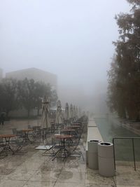 Scenic view of tables and chairs in mist