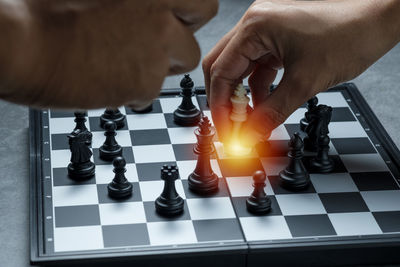 Low angle view of man playing on chess board
