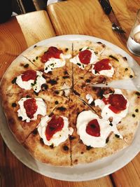 High angle view of pizza served on table