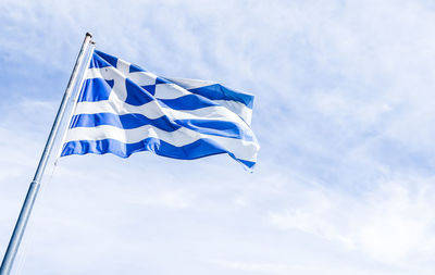 Low angle view of flag against sky