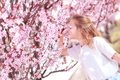 Side view of bride holding cherry blossom