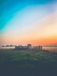 Scenic view of field against sky during sunset