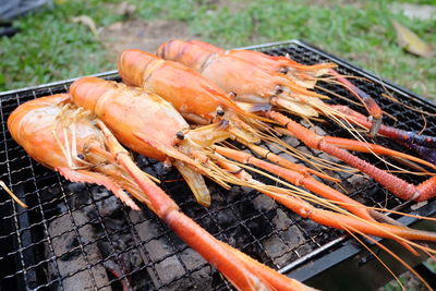 High angle view of meat on barbecue grill