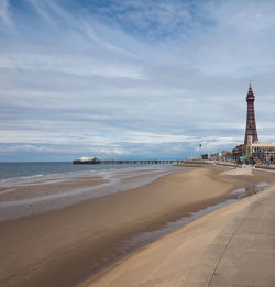 View of beach against cloudy sky