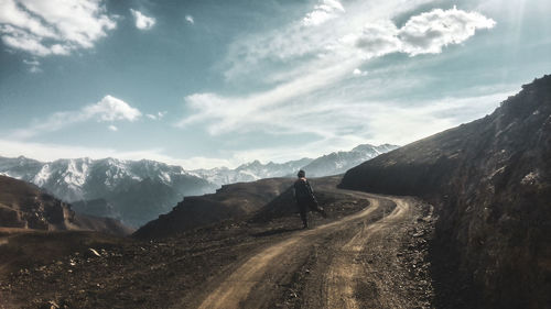 Road amidst mountains against sky