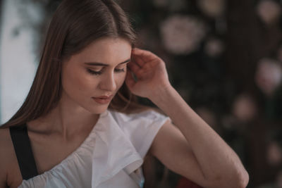 Portrait of young woman looking away outdoors