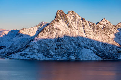 View of lake and mountains against blue sky