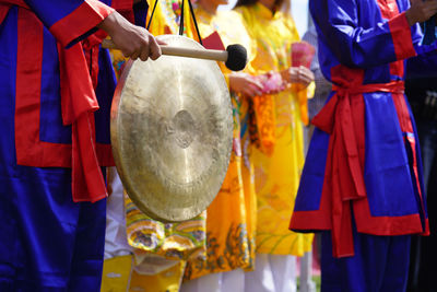 Midsection of man playing music during event