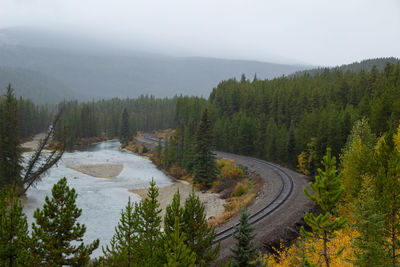 A canadian national railway loaded with carriages around the famous curve in the rocky mountains 