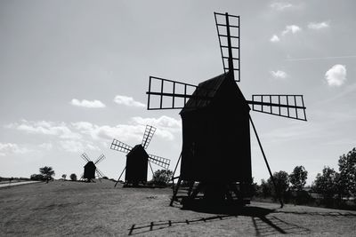 Traditional windmill on field against sky