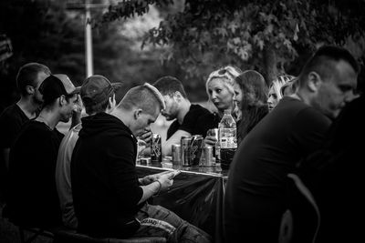 Side view of young couple sitting outdoors