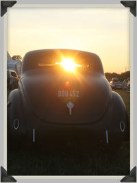 Cars on road at sunset