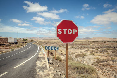 Road sign against blue sky