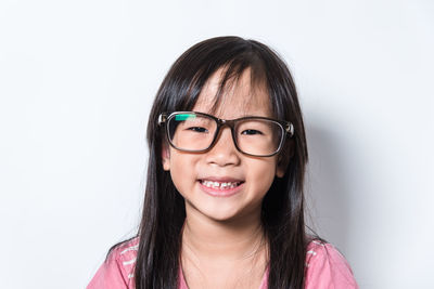 Portrait of a smiling girl against white background