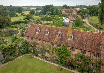 High angle view of houses by trees and buildings