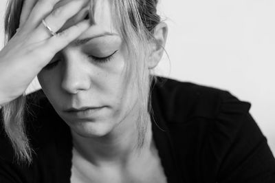 Close-up of sad woman against wall