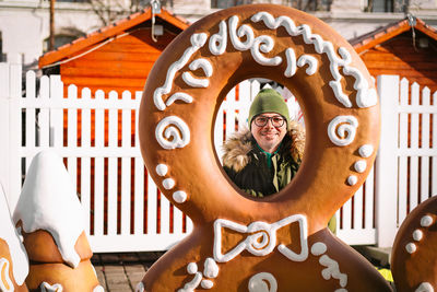 Smiling man at christmas market with gingerbread man frame