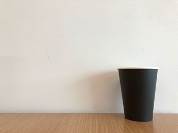 Close-up of coffee on table against wall at home