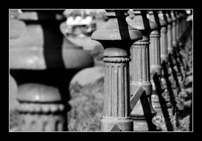 Close-up of cross on railing against building