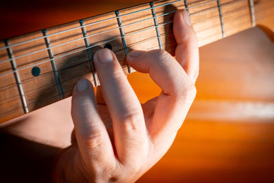 Close-up of hands playing guitar